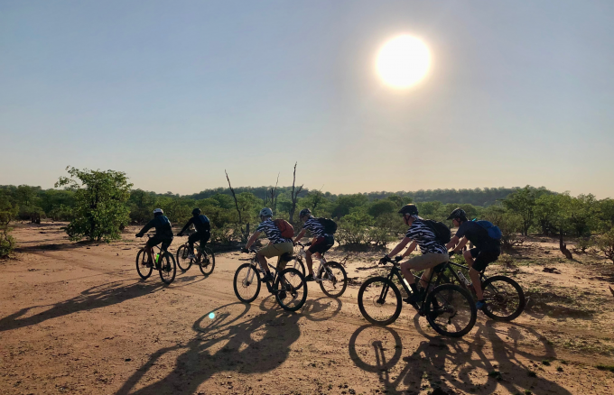 Cyclists riding through Botswana Cycle Tour | Outland Escape